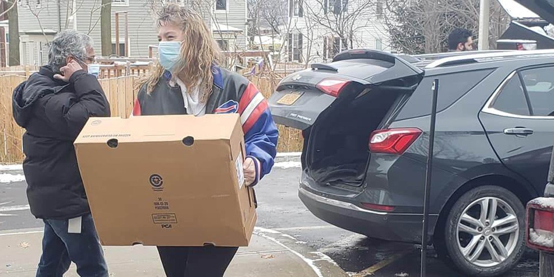 A woman, Krystina Kurucz, delivers turkeys to the Rescue Mission of Utica, NY.